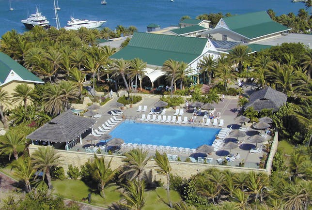 St James's Club Antigua aerial shot of pool sun loungers umbrellas palm trees