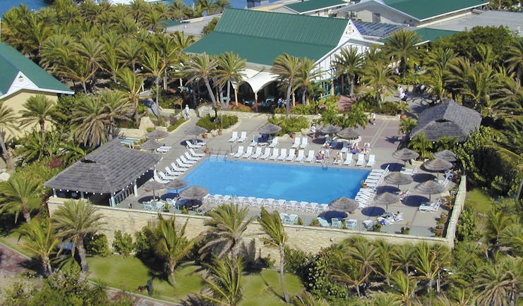 St James's Club Antigua aerial shot of pool sun loungers umbrellas palm trees
