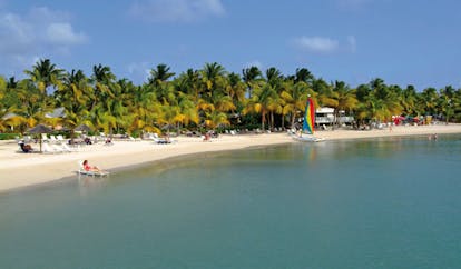 St James's Club Antigua sea and beach sun loungers boats palm trees