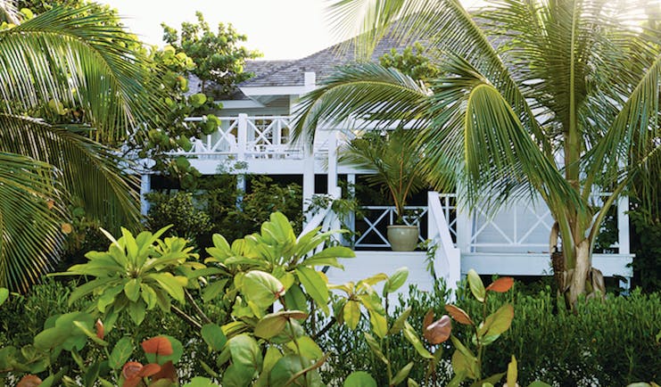 Kamalame Cay Bahamas exterior shot building surrounded by palm trees and greenery