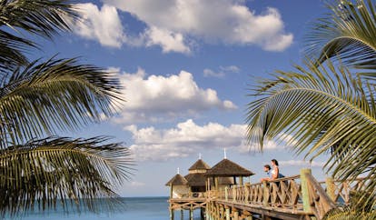 Kamalame Cay Bahamas ocean palm trees bridge to pagoda in the sea