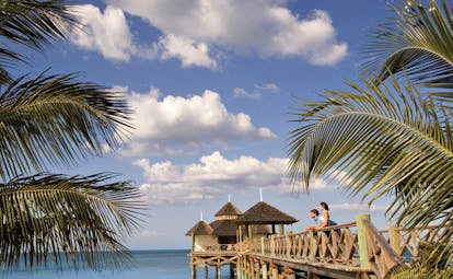 Kamalame Cay Bahamas ocean palm trees bridge to pagoda in the sea