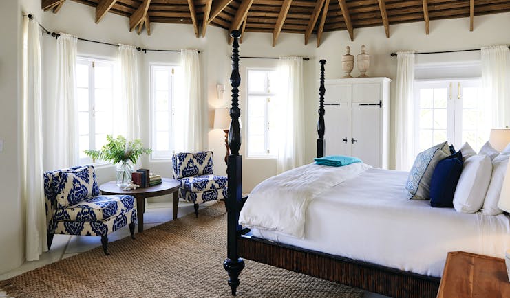 Kamalame Cay Bahamas villa bedroom  with armchairs and wardrobes 