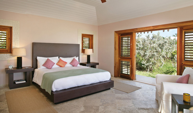 Pink Sands Bahamas bedroom minimal modern decor armchair doors to garden