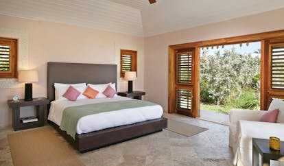 Pink Sands Bahamas bedroom minimal modern decor armchair doors to garden