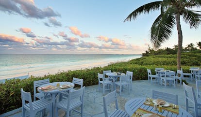 Pink Sands Bahamas blue bar outdoor dining area white tables garden and ocean view