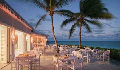 Pink Sands Bahamas Blue Bar outdoor dining area palm trees ocean view
