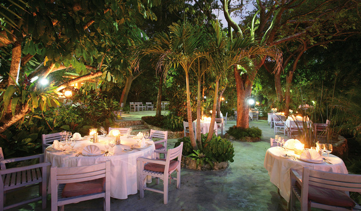 Pink Sands Bahamas garden terrace outdoor dining area in garden at night