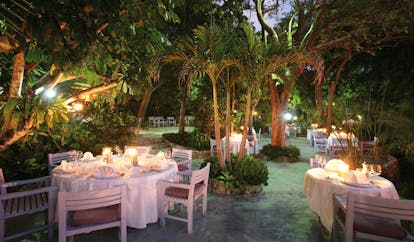 Pink Sands Bahamas garden terrace outdoor dining area in garden at night