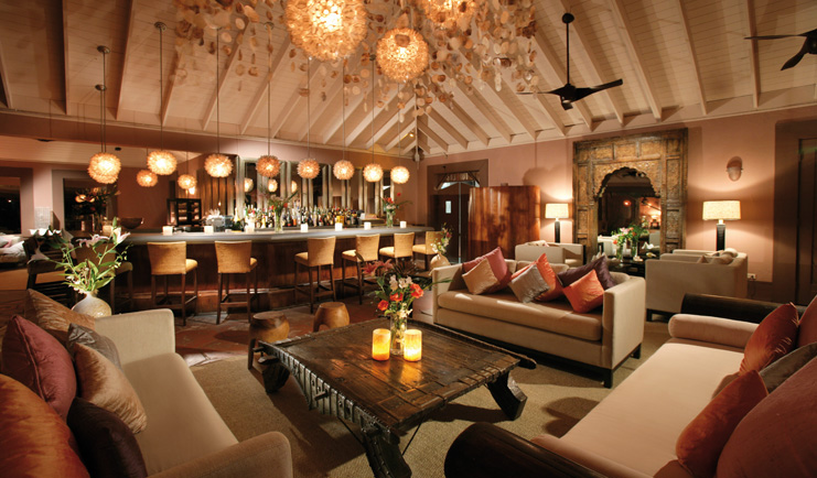 Pink Sands Bahamas lobby bar area with sofas and armchairs carved archway