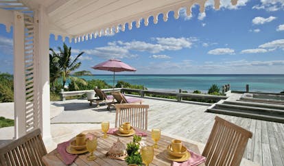 Pink Sands Bahamas outdoor deck dining covered and open deck sun lounger ocean view