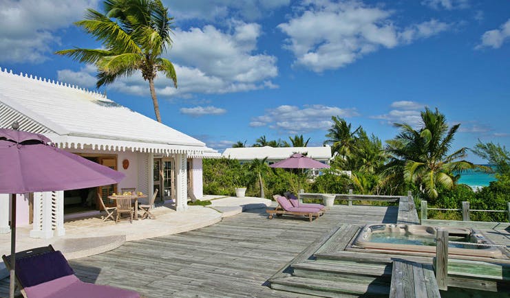 Pink Sands Bahamas villa deck white bungalow hot tub sun loungers ocean view
