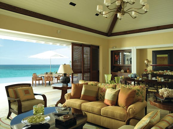 Four Seasons Ocean Club Bahamas villa lounge sofa armchairs dining area and outdoor seating area