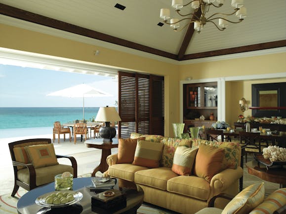 Four Seasons Ocean Club Bahamas villa lounge sofa armchairs dining area and outdoor seating area