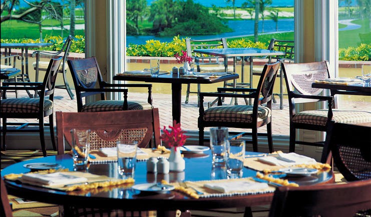 One and Only Ocean Club Bahamas clubhouse restaurant classic decor dining area with golf course view