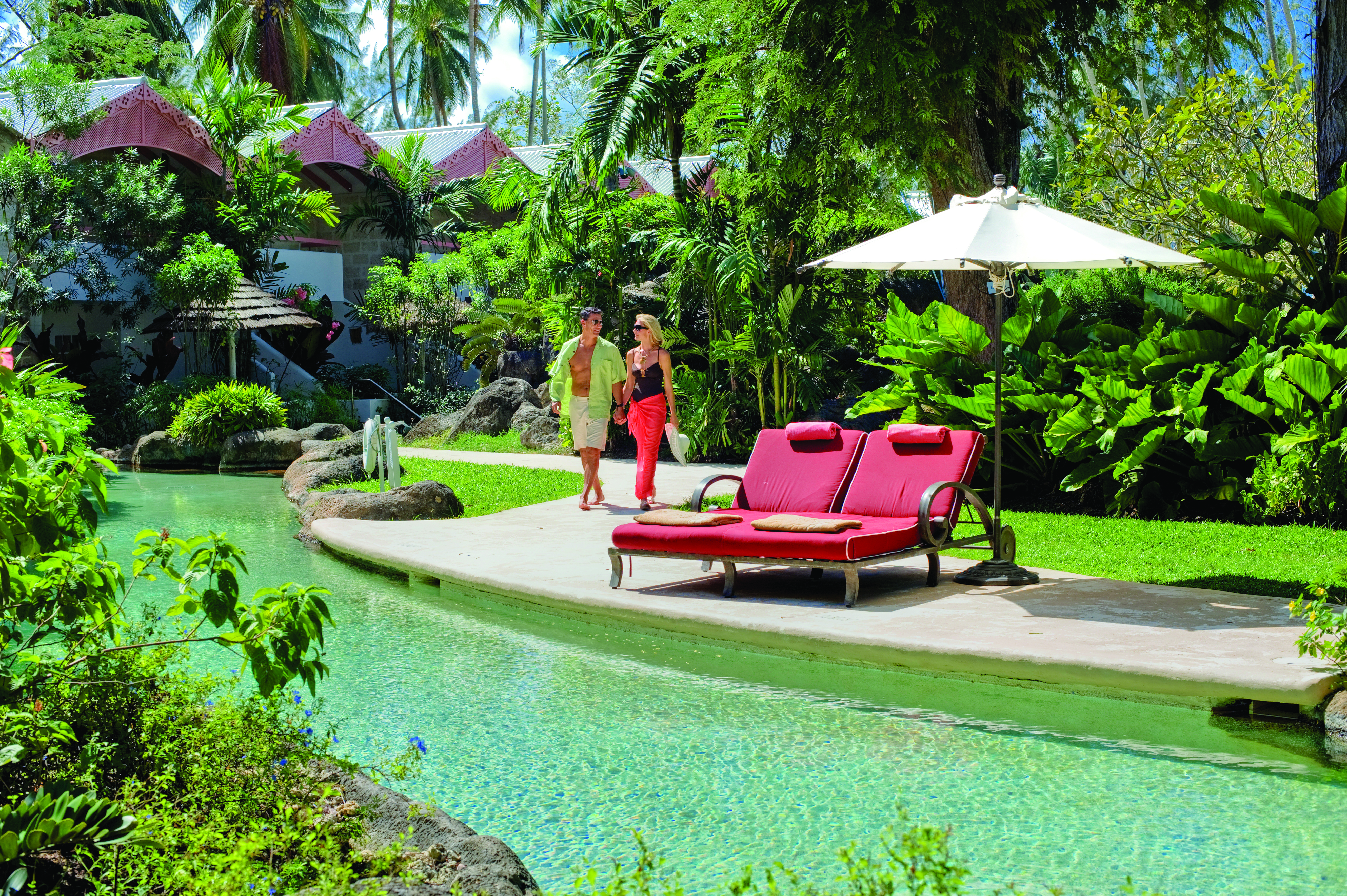 Colony Club Barbados poolside sun loungers and umbrella at side of pool