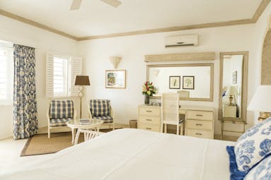 Coral Reef Club Barbados bedroom with living area and dressing table
