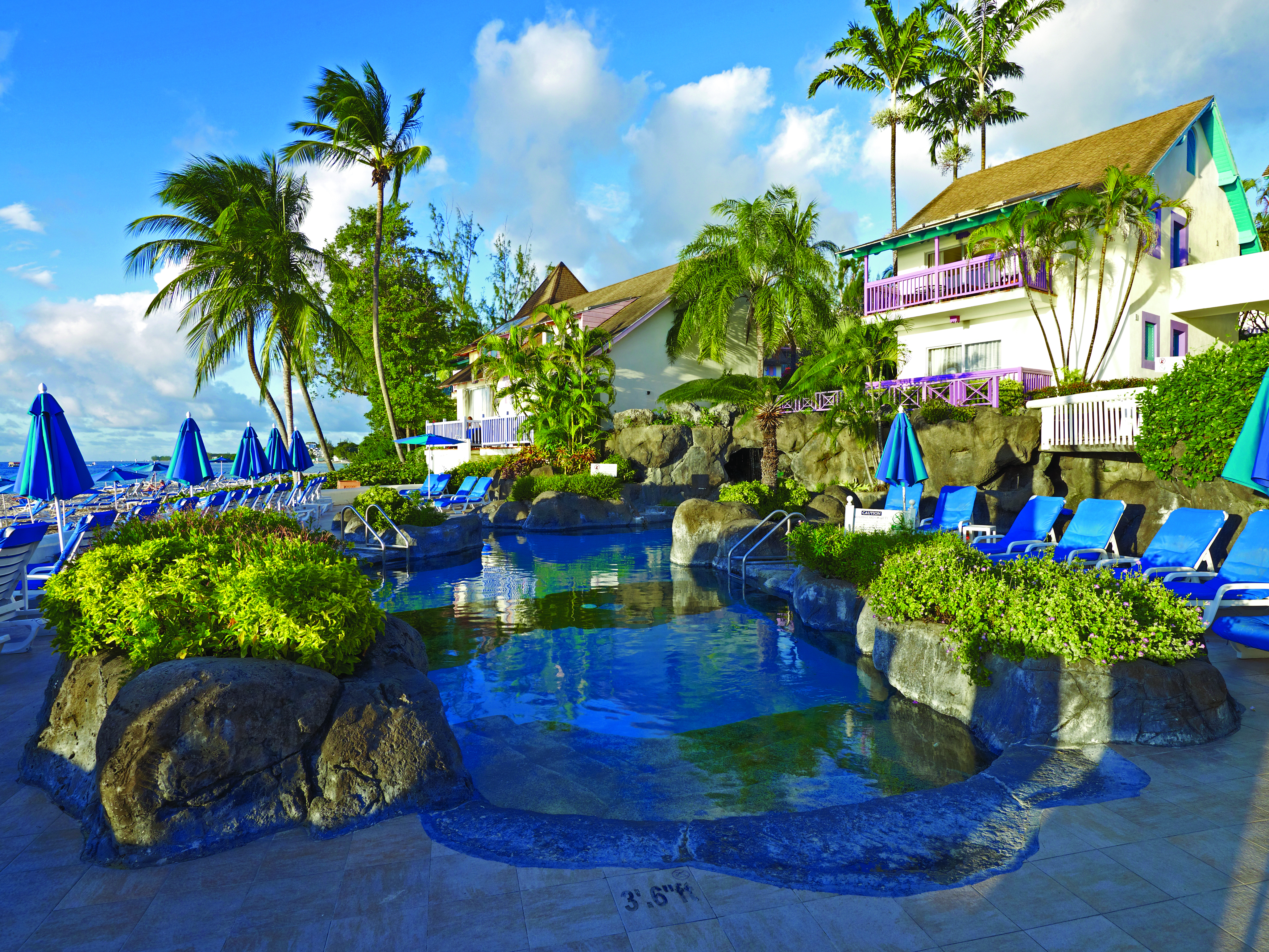 Crystal Cove Barbados pool and sun loungers view of hotel in the background