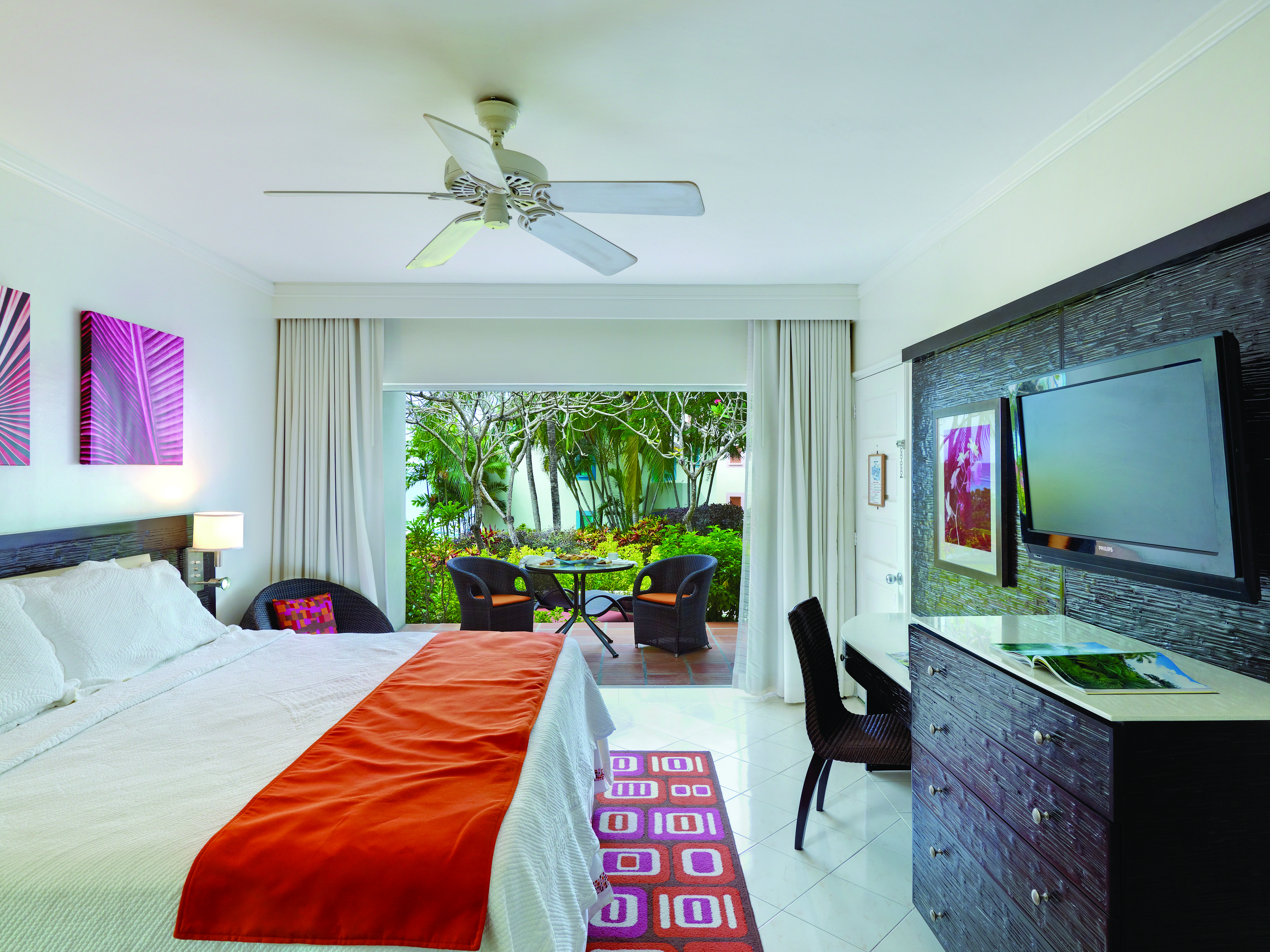 Crystal Cove Barbados standard room bedroom with outdoor seating area 