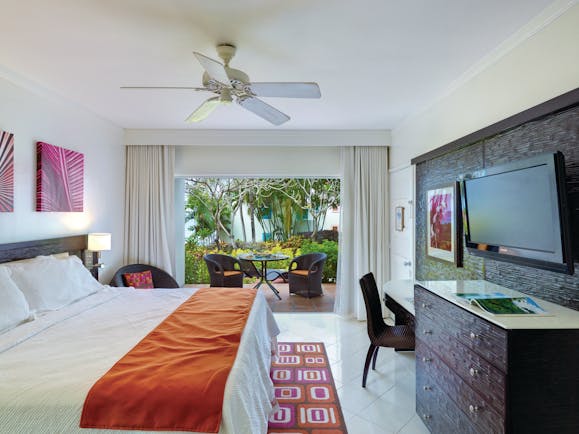 Crystal Cove Barbados standard room bedroom with outdoor seating area 