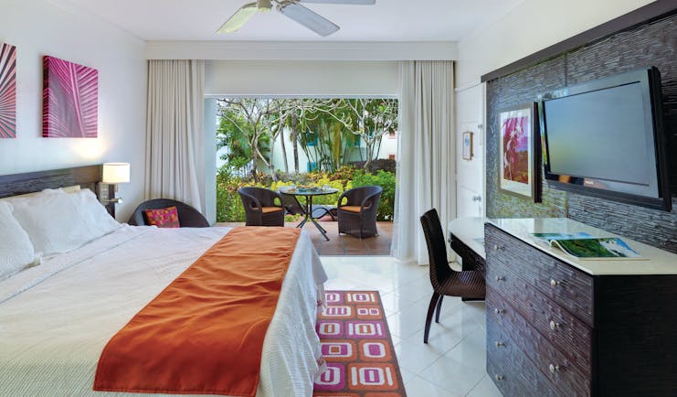 Crystal Cove Barbados standard room bedroom with outdoor seating area 