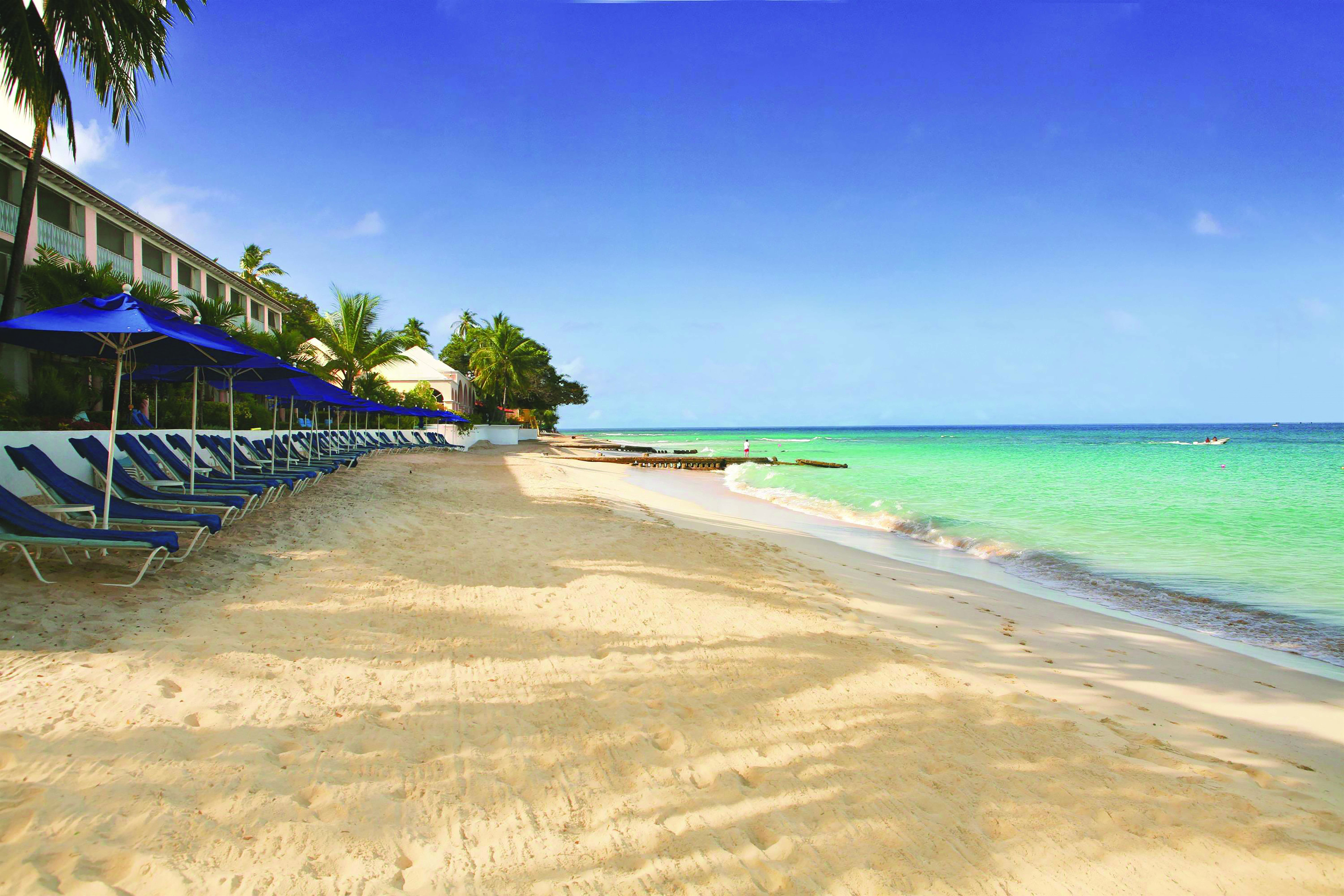 Fairmont Royal Pavilion Barbados beach with sun loungers and umbrellas