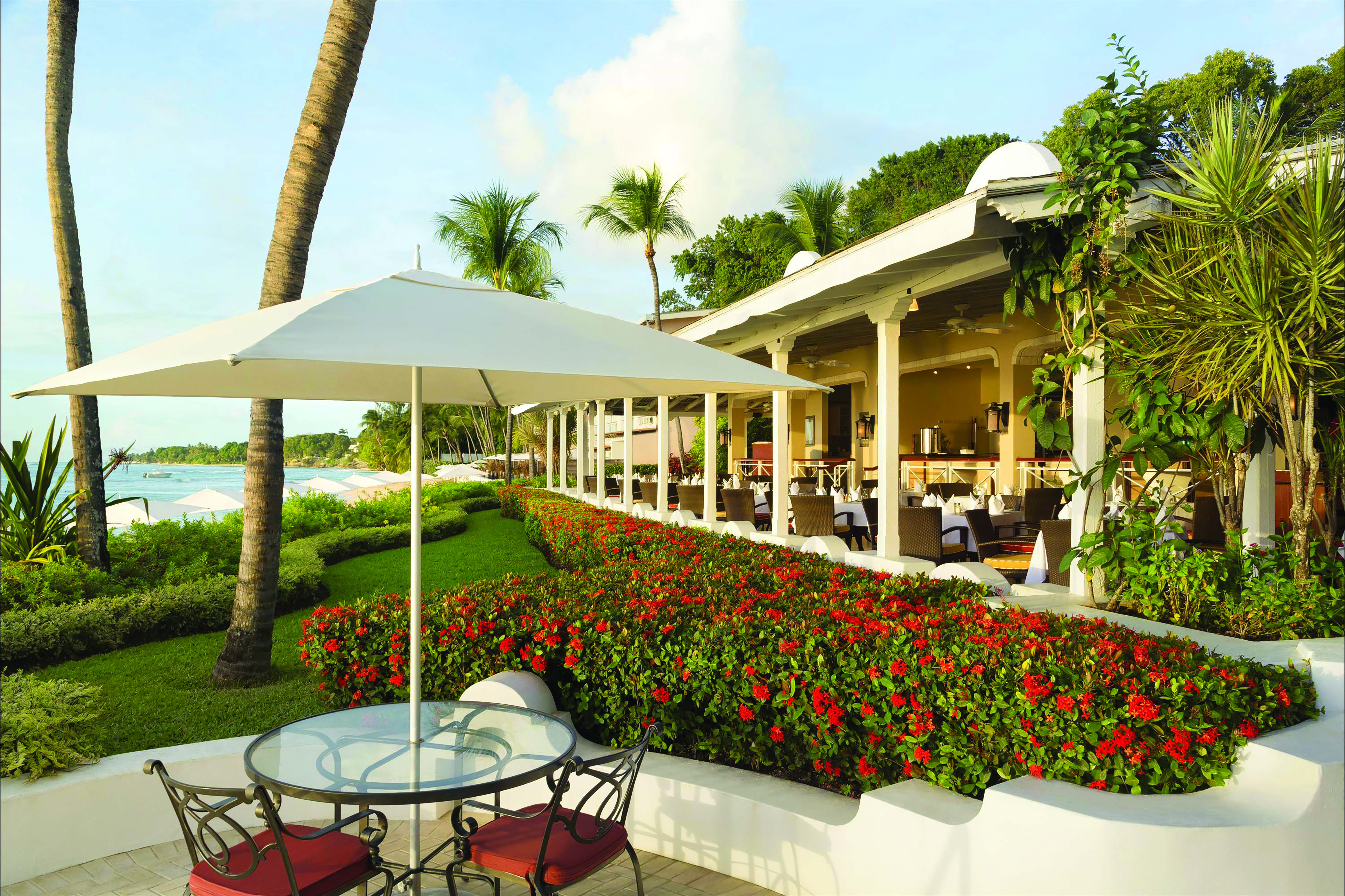 Fairmont Royal Pavilion Barbados outdoor seating beach and restaurant in background