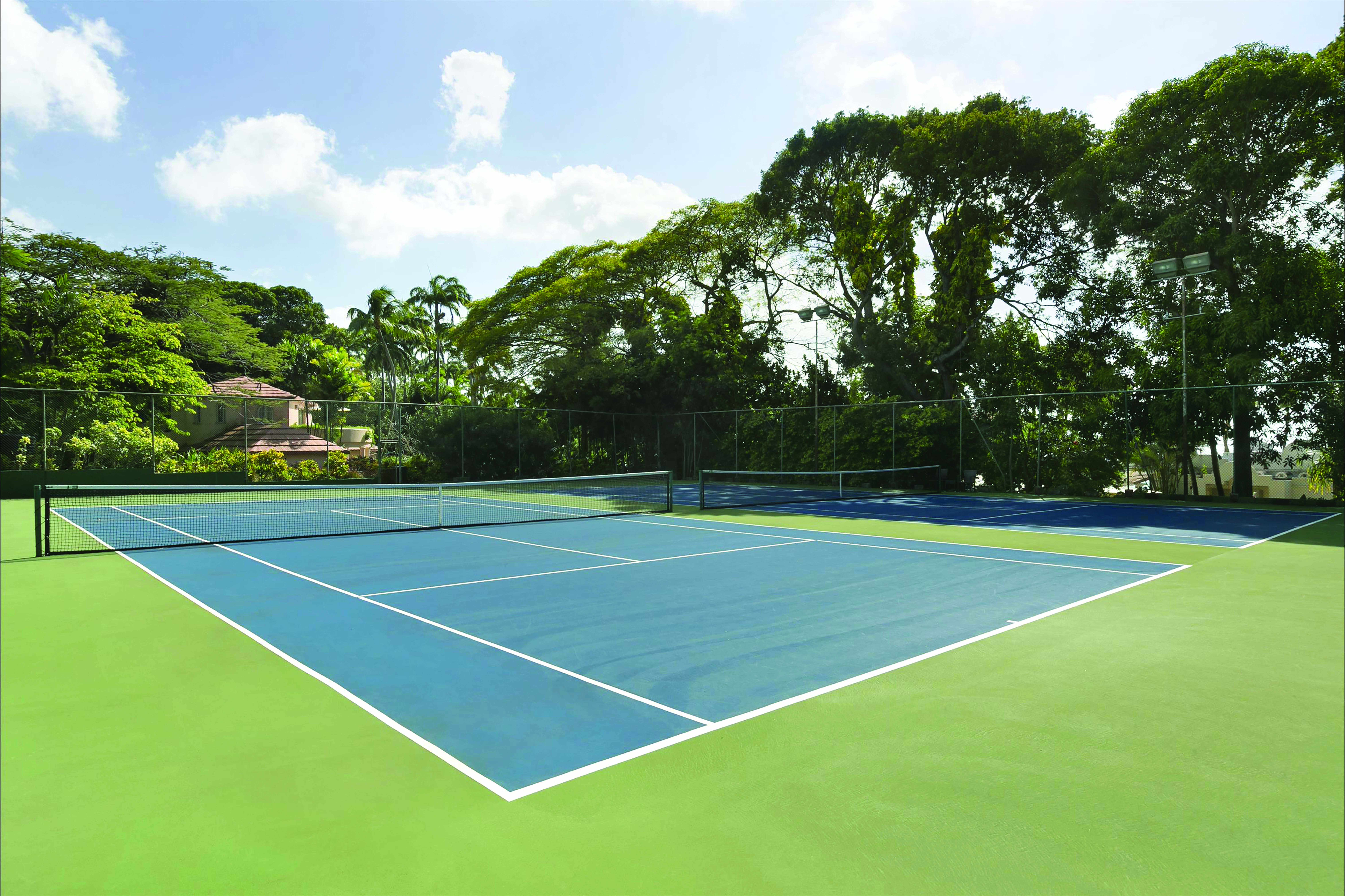 Fairmont Royal Pavilion Barbados tennis court surrounded by trees