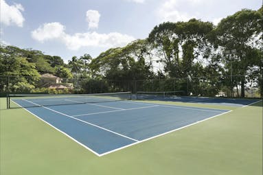 Fairmont Royal Pavilion Barbados tennis court surrounded by trees