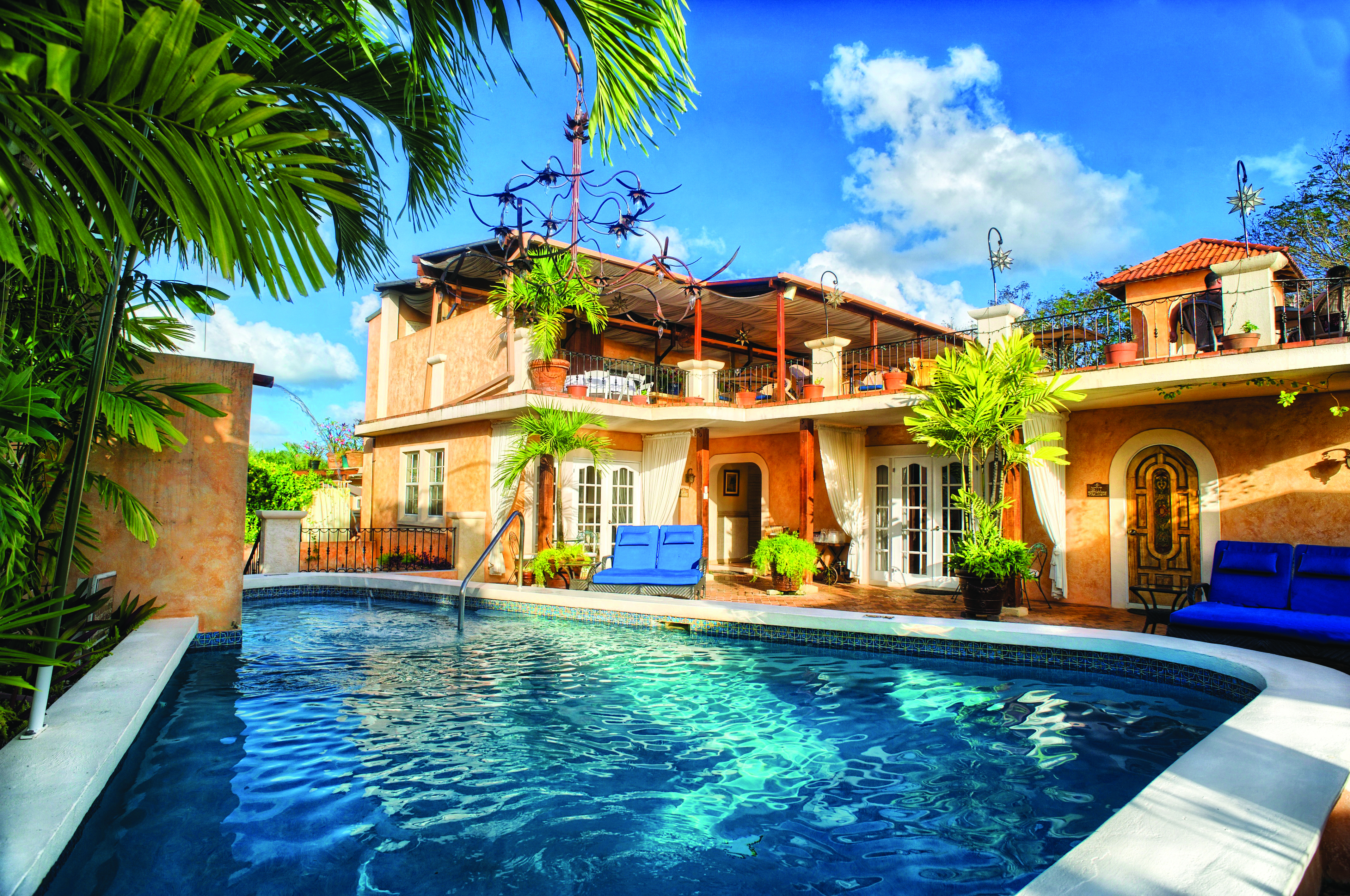 Little Arches Barbados main building with pool and palm trees