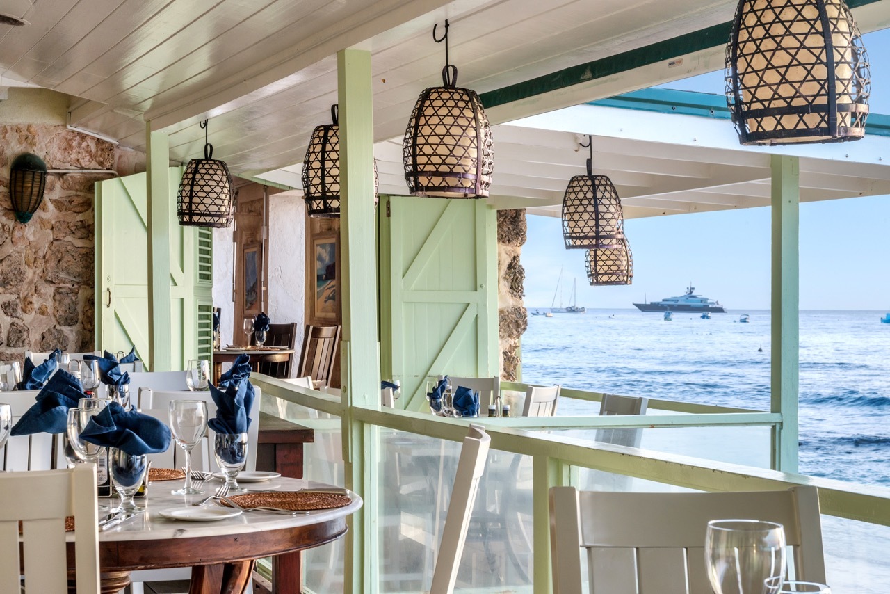 Little Good Harbour Fish Pot Restaurant views, looking out across the sea from within the stone-walled building