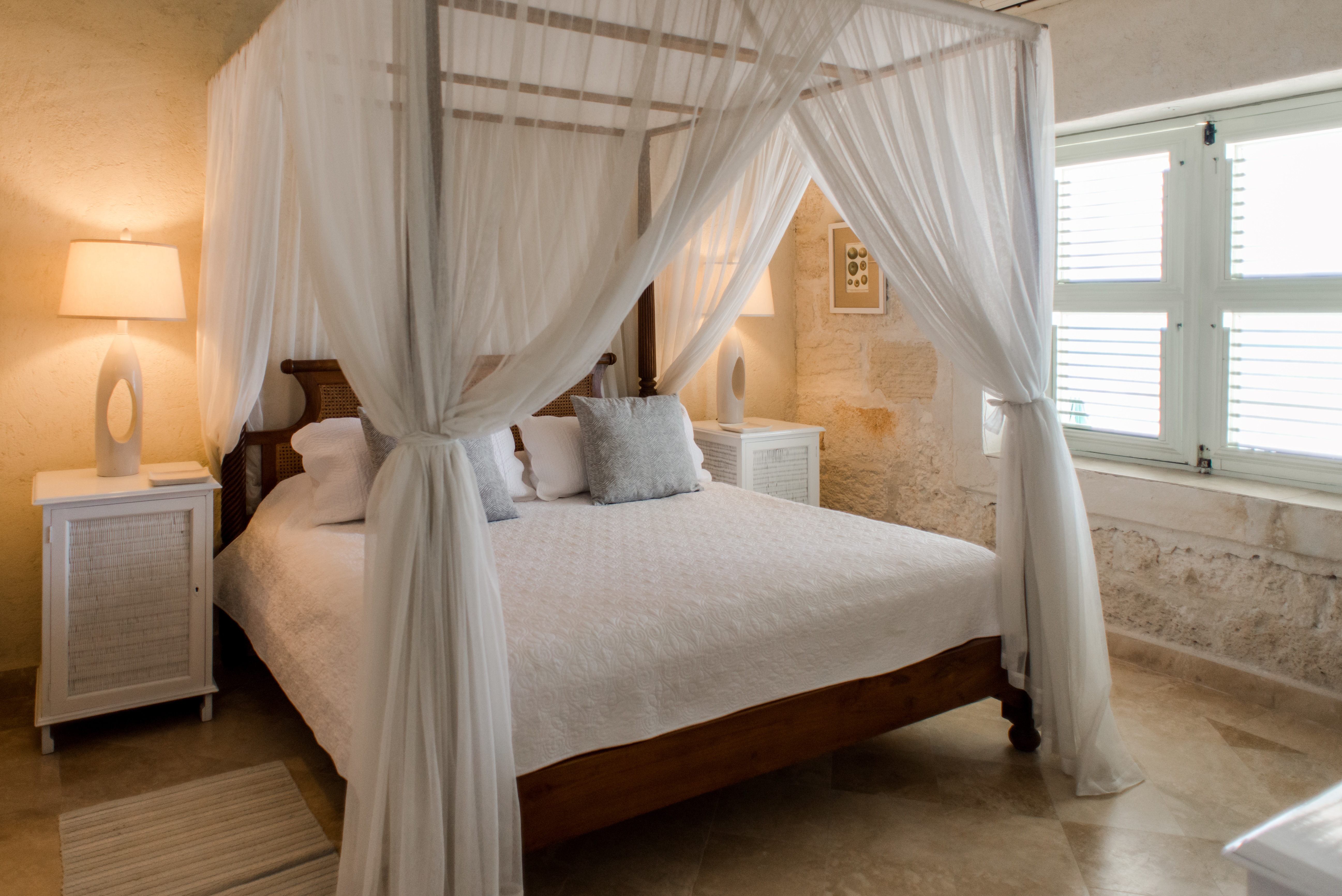 Little Good Harbour Three Bedroom Fort Suite, with stone exterior wall and white canopy bed