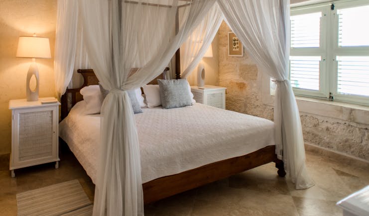 Little Good Harbour Three Bedroom Fort Suite, with stone exterior wall and white canopy bed