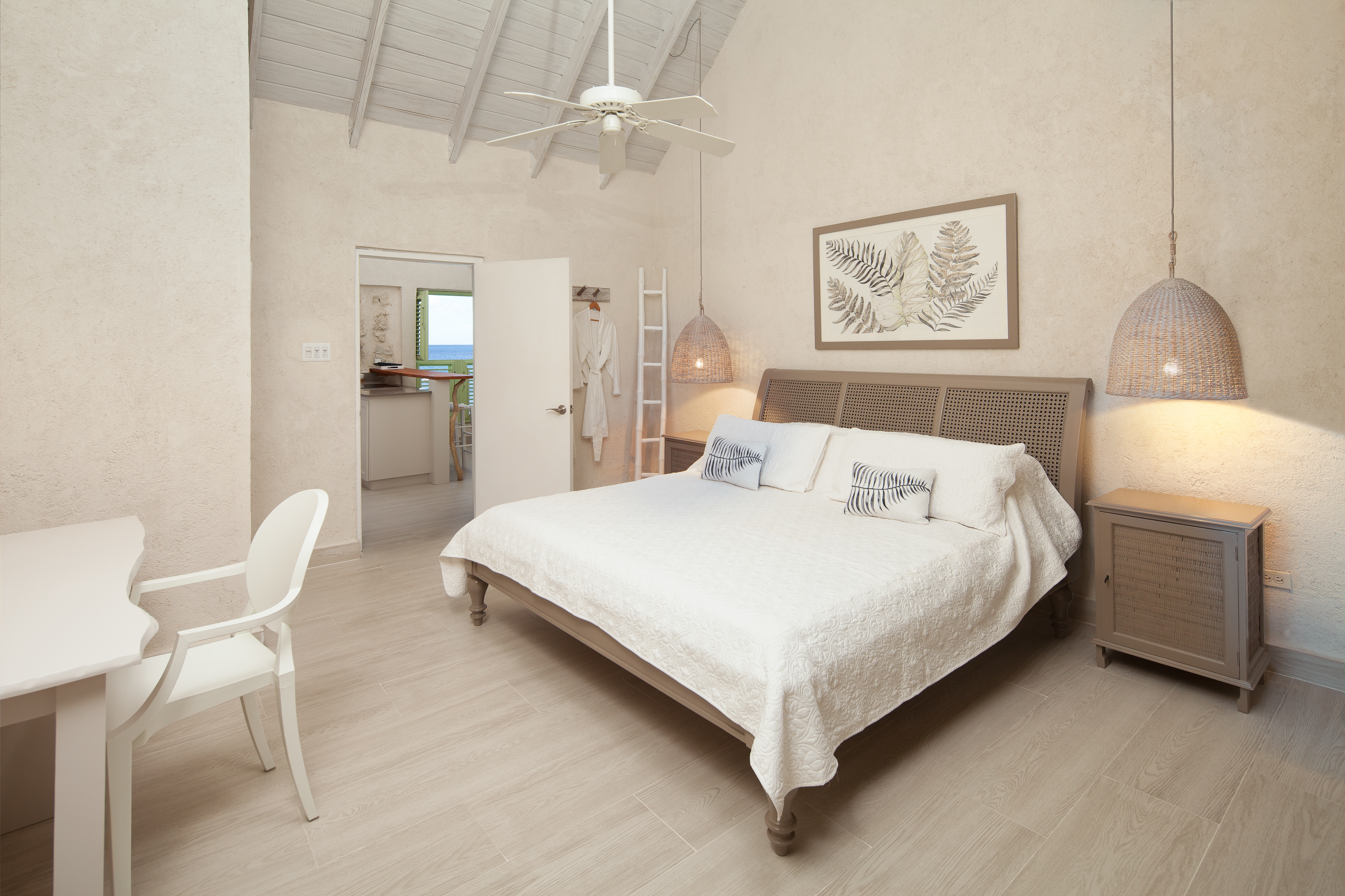 Little Good Harbour Two Bedroom Fort Suite king bedroom in light earthy colours, with low-hanging lights and a dressing area