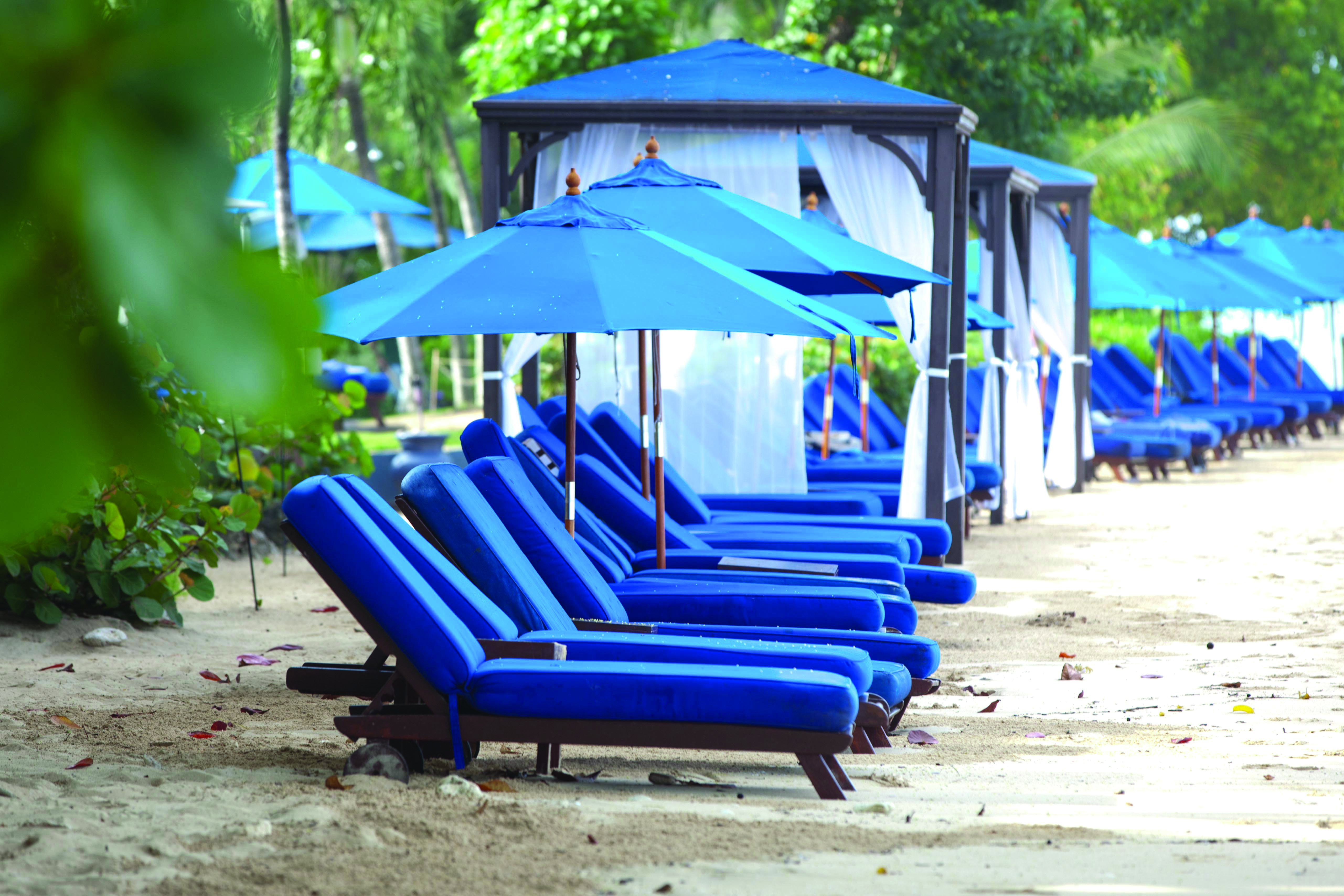 The House Barbados beach sun loungers and umbrellas