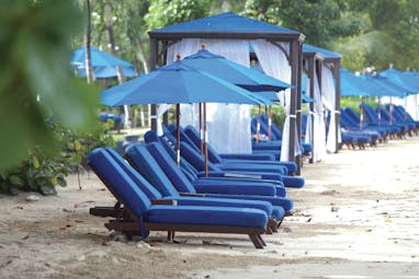 The House Barbados beach sun loungers and umbrellas