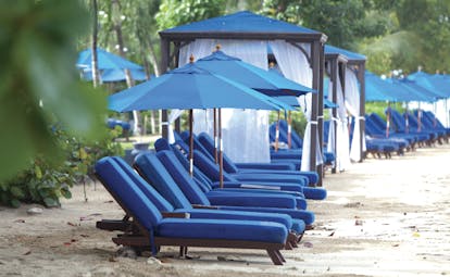 The House Barbados beach sun loungers and umbrellas