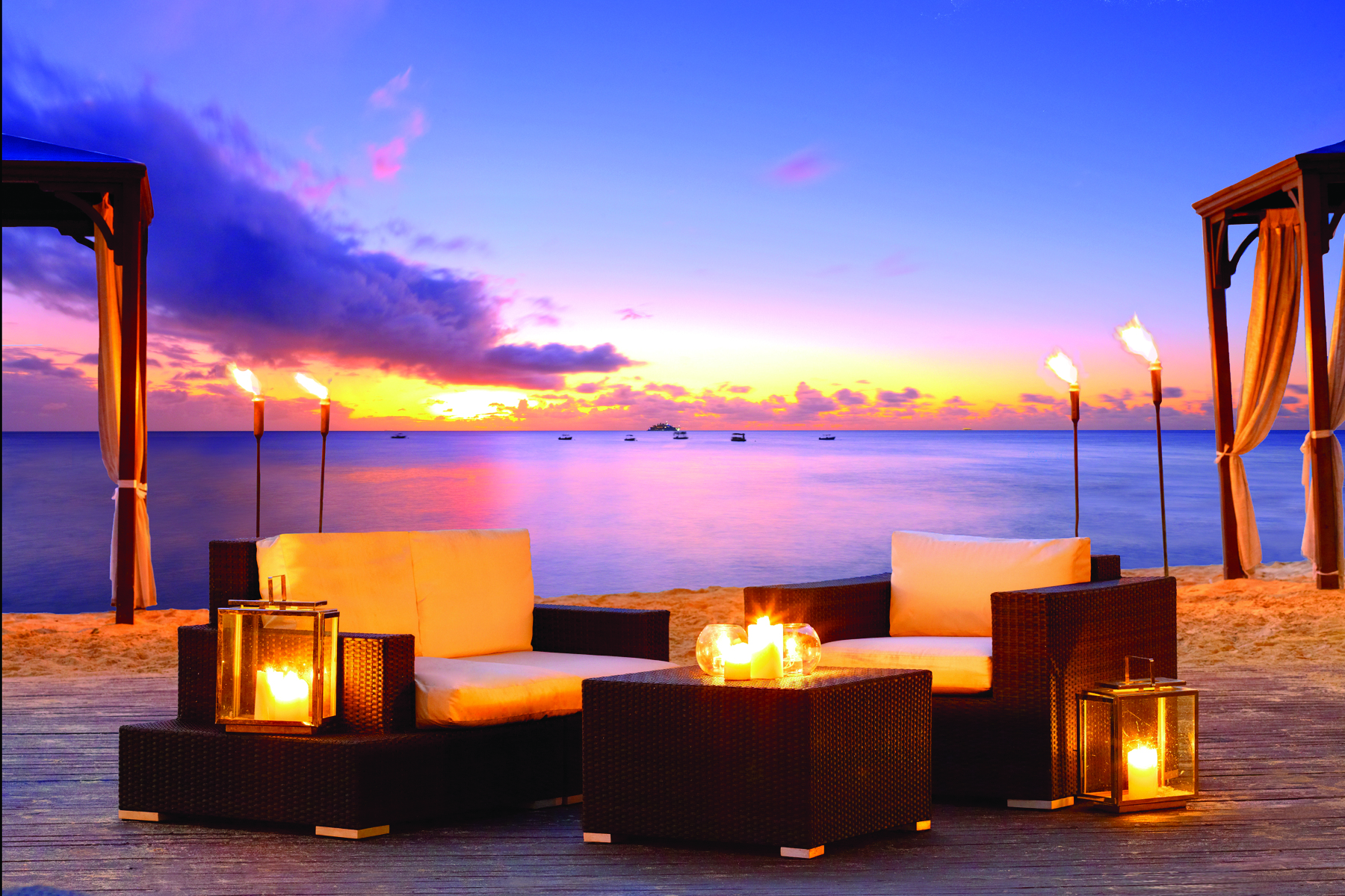 The House Barbados outdoor seating area on the beach at sunset