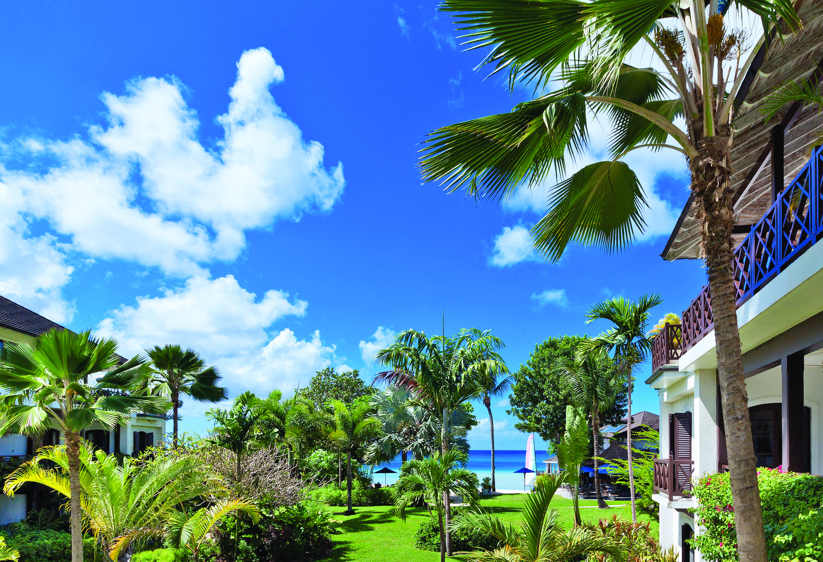 Sandpiper Barbados exterior hotel buildings palm trees and ocean in the distance