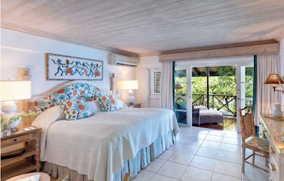 Sandpiper Barbados garden room bedroom leading to terrace with sun loungers 