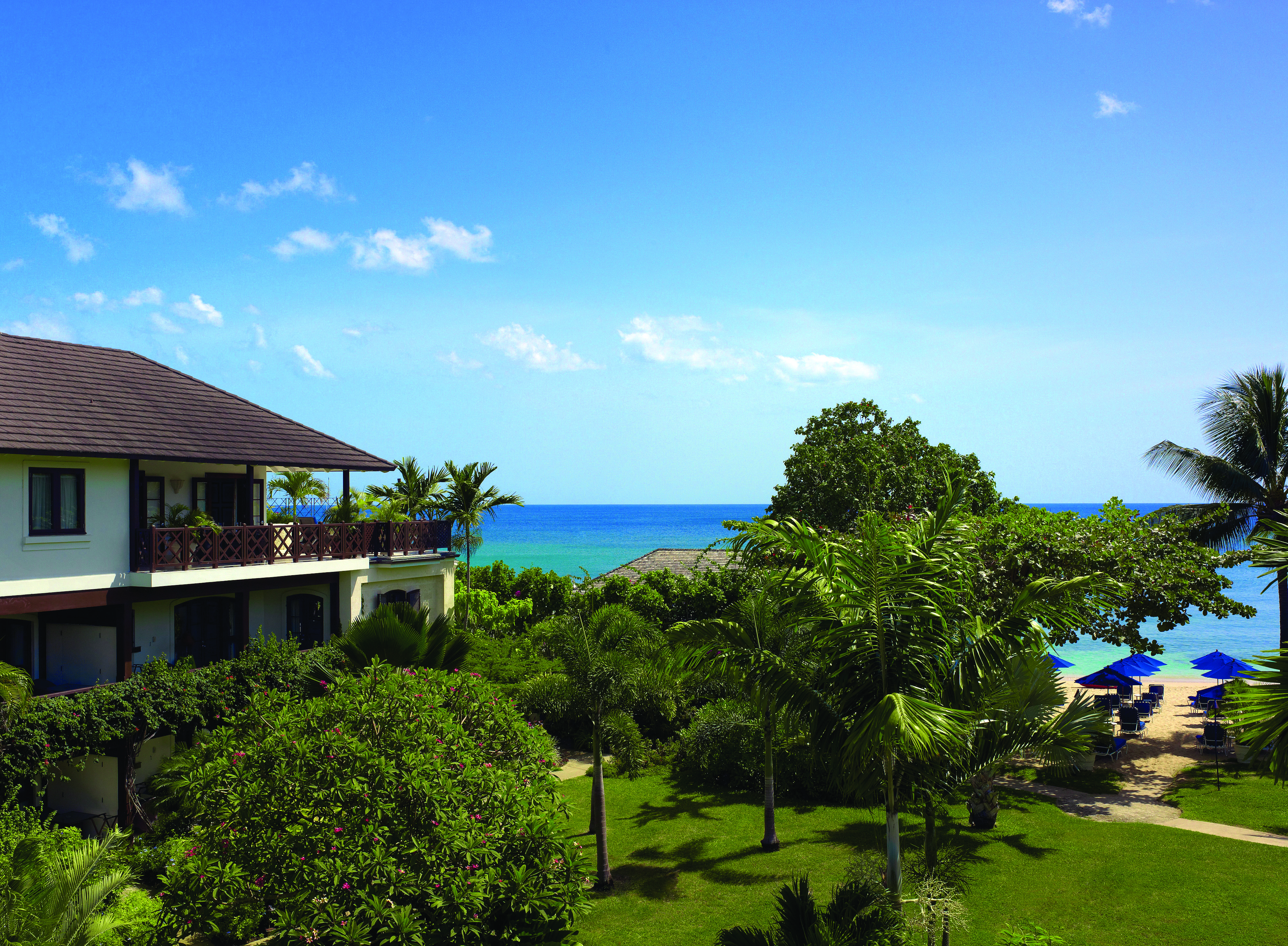 Sandpiper Barbados gardens palm trees and lawn leading to beach