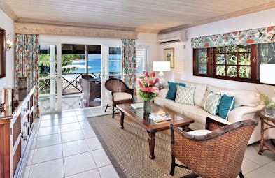 Sandpiper Barbados one bedroom suite lounge leading to terrace seating area with beach views