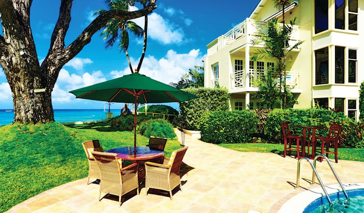 Treasure Beach Barbados outdoor dining area beside pool with views of the ocean