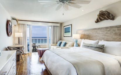 Waves Barbados suite bed and living area and balcony with ocean views