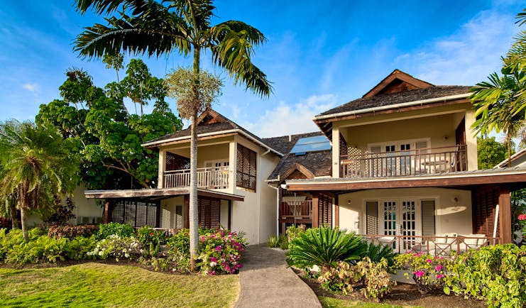 Two storey wooden balconies and palm