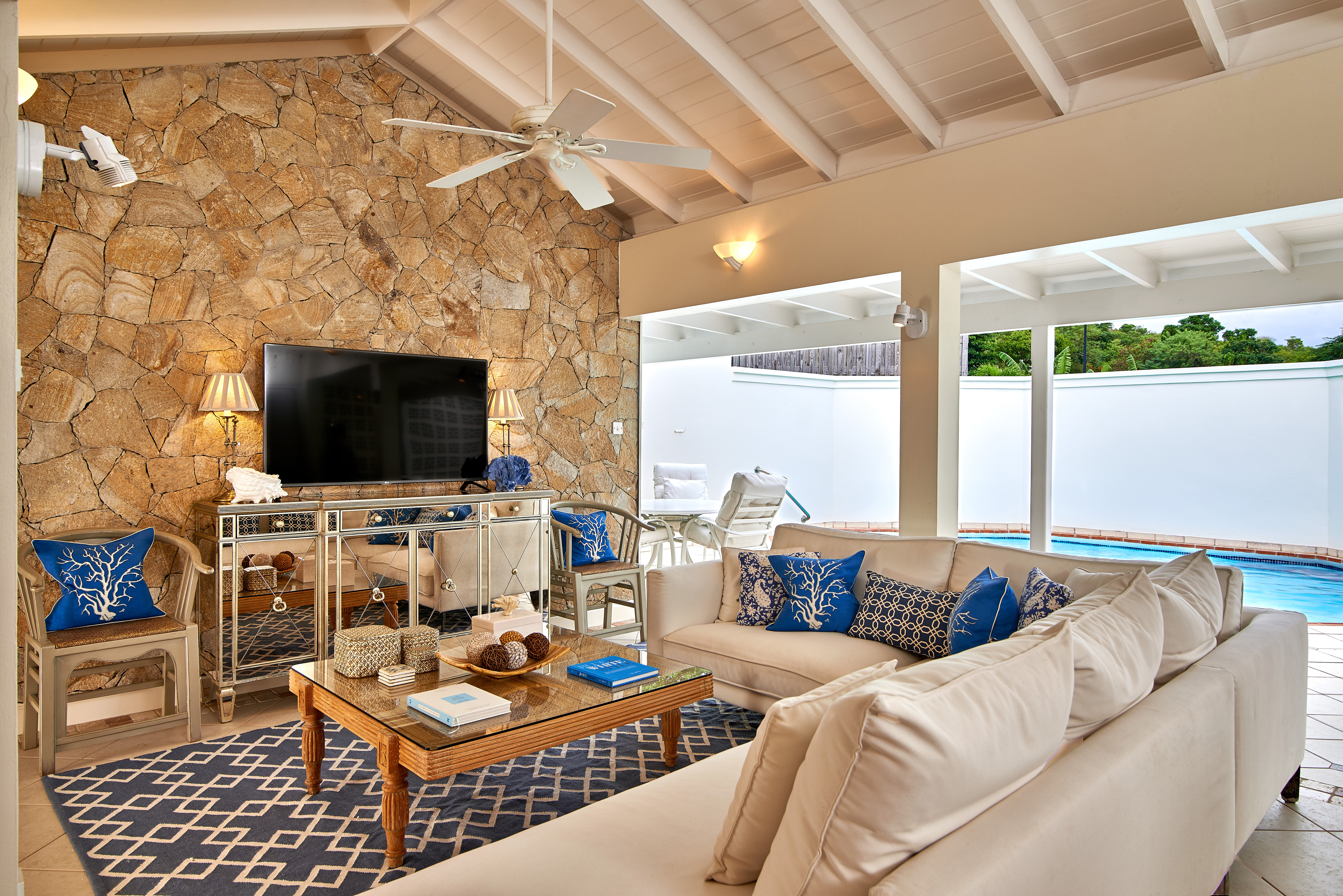 Living room with stone wall and ceiling fan