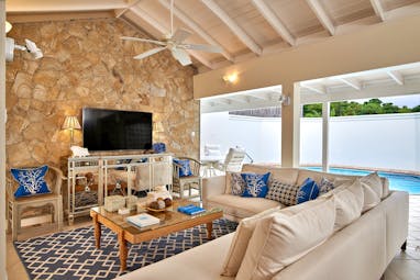 Living room with stone wall and ceiling fan