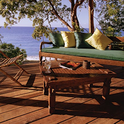 Laluna Grenada cottage veranda outdoor seating area overlooking the beach