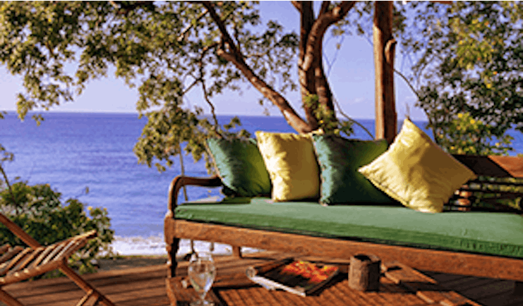 Laluna Grenada cottage veranda outdoor seating area overlooking the beach