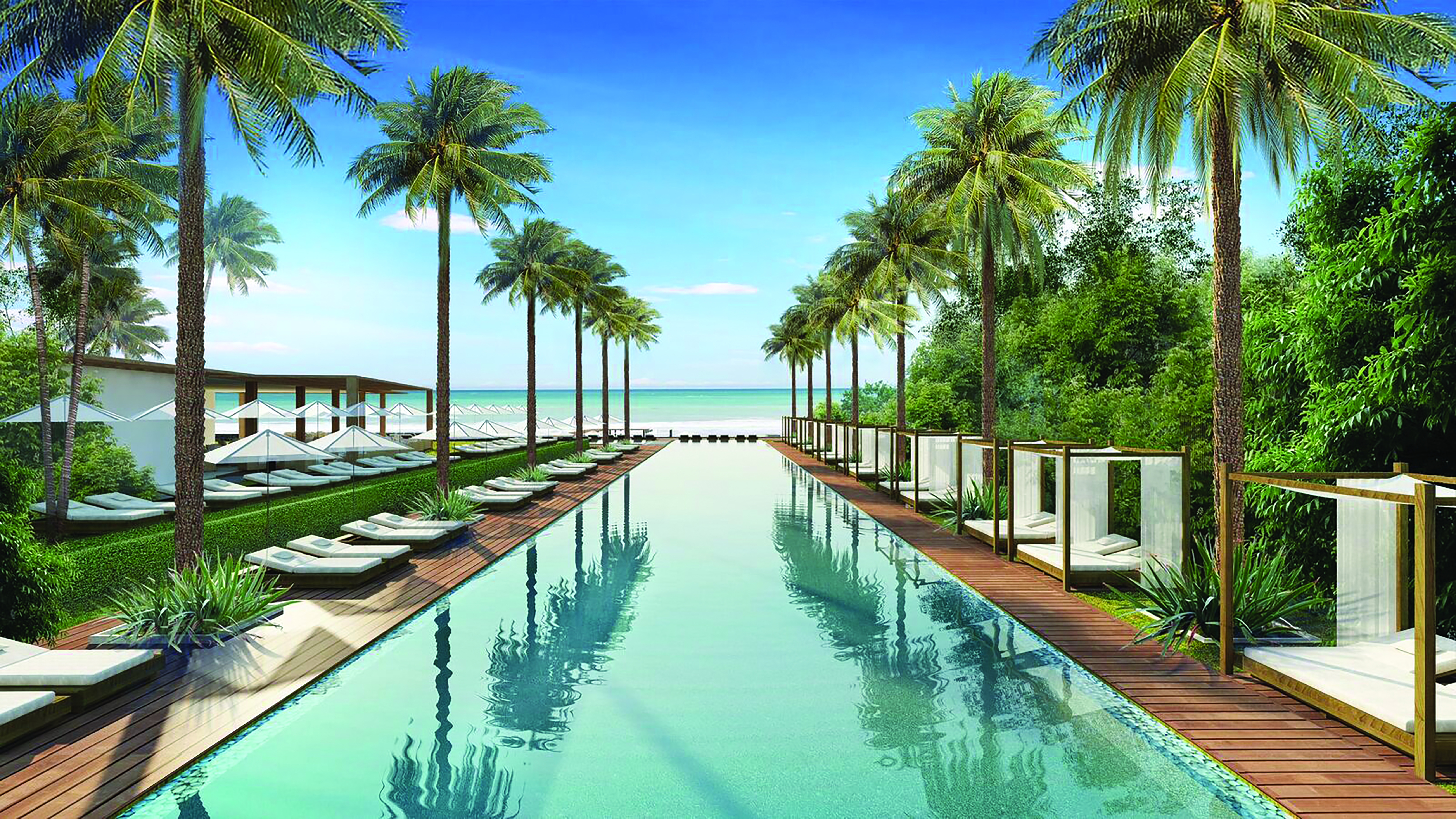 Silversands Grenada main pool long swimming pool overlooking the ocean lined with sun loungers and palm trees